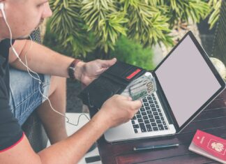 How to Build an Emergency Fund: Tips for Saving Money Quickly man holding black leather wallet