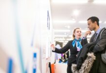 Why Your Company Should Consider a Hiring Platform man and woman talking near the wall