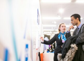 Why Your Company Should Consider a Hiring Platform man and woman talking near the wall