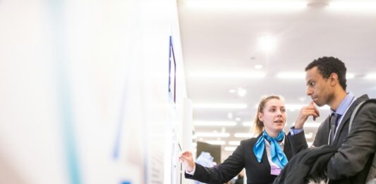 Why Your Company Should Consider a Hiring Platform man and woman talking near the wall