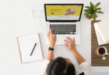 Is Your Brand Voice Helping or Hurting Your Reputation? a person sitting at a desk with a laptop and a coffee cup