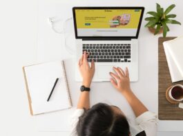 Is Your Brand Voice Helping or Hurting Your Reputation? a person sitting at a desk with a laptop and a coffee cup