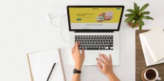 Is Your Brand Voice Helping or Hurting Your Reputation? a person sitting at a desk with a laptop and a coffee cup