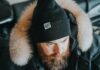 Stay Cosy, Stay Seen: How Branded Beanies Keep Your Business Top of Mind a man with a beard wearing a black hat