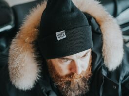 Stay Cosy, Stay Seen: How Branded Beanies Keep Your Business Top of Mind a man with a beard wearing a black hat