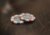 Cosmo Kasino: Ein Zentrum für spannende Turniere und vielfältige Tischspiele two poker chips sitting on top of a wooden table
