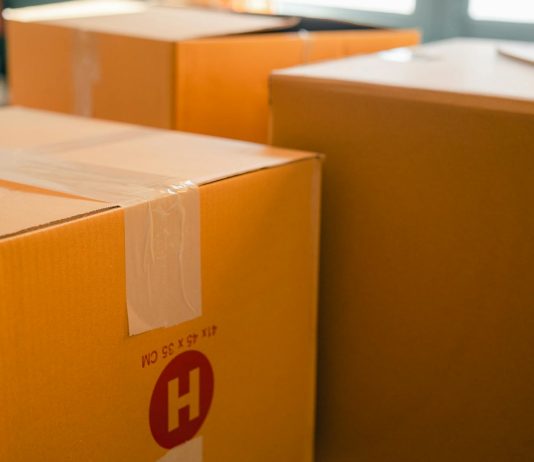 Factors That Affect Your Final Shipping Price Cardboard containers sealed with sticky tape for relocation placed near window on sunny day