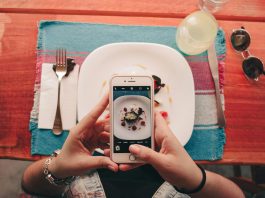Is Instagram the Coolest Entertainment Platform? A woman takes a photo of a dessert with her smartphone at a restaurant.