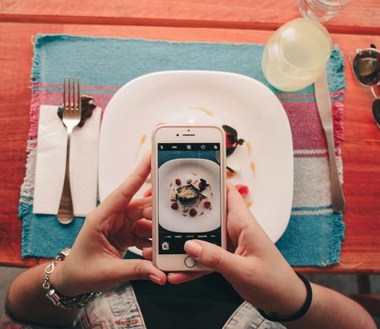 Is Instagram the Coolest Entertainment Platform? A woman takes a photo of a dessert with her smartphone at a restaurant.
