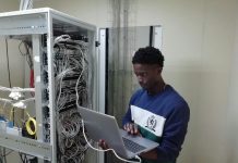 Your Guide On How To Recover Data From The External Hard Drive man in blue sweater using silver macbook