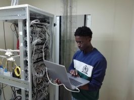 Your Guide On How To Recover Data From The External Hard Drive man in blue sweater using silver macbook