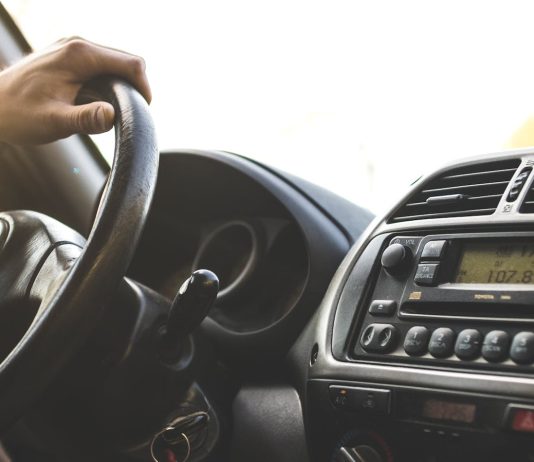 How Field Sobriety Tests Can Be Challenged In Court Close-up of a hand on a steering wheel inside a car, dashboard visible.