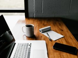 Why Use a Home Loan Calculator Before Applying for a Home Loan? MacBook Pro, white ceramic mug,and black smartphone on table