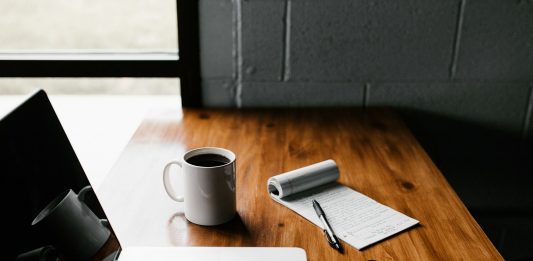 Why Use a Home Loan Calculator Before Applying for a Home Loan? MacBook Pro, white ceramic mug,and black smartphone on table