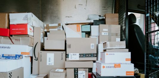 Why Your Online Orders Keep Getting Delayed (And How to Fix It) brown cardboard boxes on black plastic crate