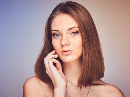 How to Restore Volume to Your Face Without Looking Overdone woman with her hand on cheek