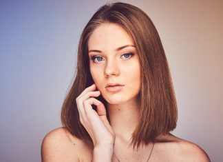 How to Restore Volume to Your Face Without Looking Overdone woman with her hand on cheek