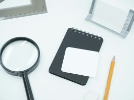 How Background Checks Play a Role in Corporate Investigations black magnifying glass on white paper