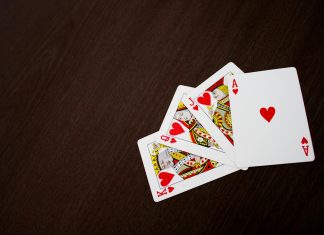 What Modern Casino Security Really Looks Like Elegant flat lay of playing cards featuring ace of hearts on a wooden surface.