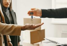 Overcoming Obstacles in Securing Financing as a Foreign Real Estate Buyer A new homeowner receives keys inside their new home, symbolizing a fresh start.