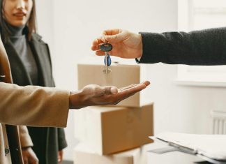 Overcoming Obstacles in Securing Financing as a Foreign Real Estate Buyer A new homeowner receives keys inside their new home, symbolizing a fresh start.