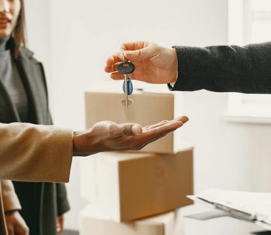 Overcoming Obstacles in Securing Financing as a Foreign Real Estate Buyer A new homeowner receives keys inside their new home, symbolizing a fresh start.