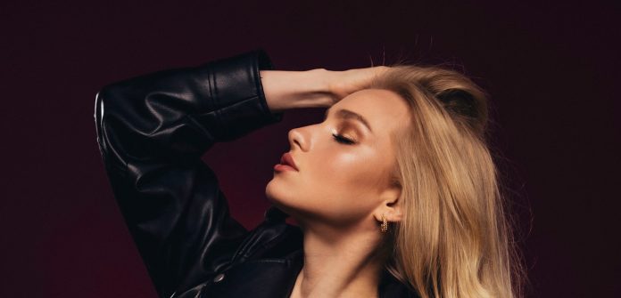 Photo by VENUS MAJOR a woman in a leather jacket posing for a picture