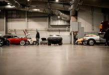 What Every Car Enthusiast Should Know Before Buying from an International Auction a man standing next to a row of parked cars