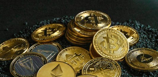 How BYDFi Puts Users First: Revolutionizing Crypto Trading With Innovative Features a pile of bitcoins sitting on top of a pile of gravel