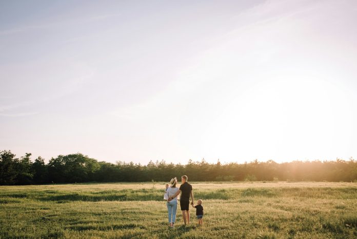 Photo by Ilya Pavlov man and woman walking on green grass field during daytime
