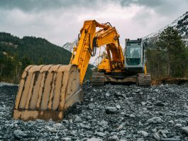 Why Lease Rather Than Buy? yellow and black excavator on rocky ground