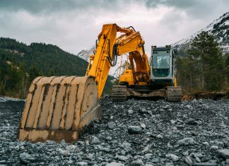 Why Lease Rather Than Buy? yellow and black excavator on rocky ground