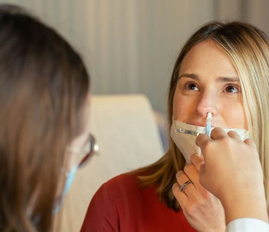 Are Nasal Sprays Enough to Treat Chronic Sinusitis — or Do You Need Surgery? a woman in a red shirt and a woman in a white shirt