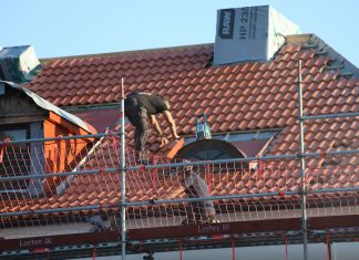5 Most Popular Certifications In The Roofing Industry A man on a roof working on a roof