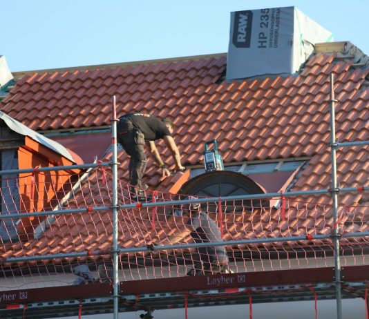 5 Most Popular Certifications In The Roofing Industry A man on a roof working on a roof