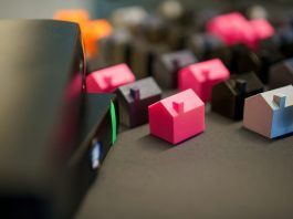 How to Handle Real Estate Contracts With Time-Is-Of-Essence Clauses Many small colorful houses arranged in rows.