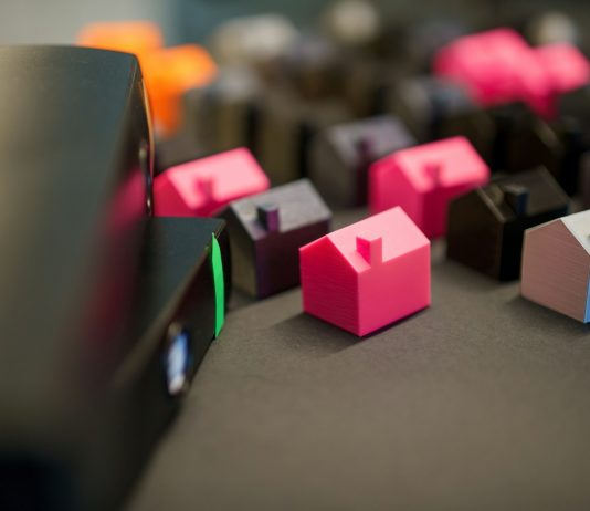 How to Handle Real Estate Contracts With Time-Is-Of-Essence Clauses Many small colorful houses arranged in rows.