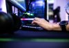 Enjoygm—Gamers’ New Choice for Cheaper Top-Up a person is typing on a laptop computer