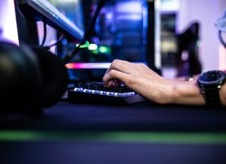 Enjoygm—Gamers’ New Choice for Cheaper Top-Up a person is typing on a laptop computer