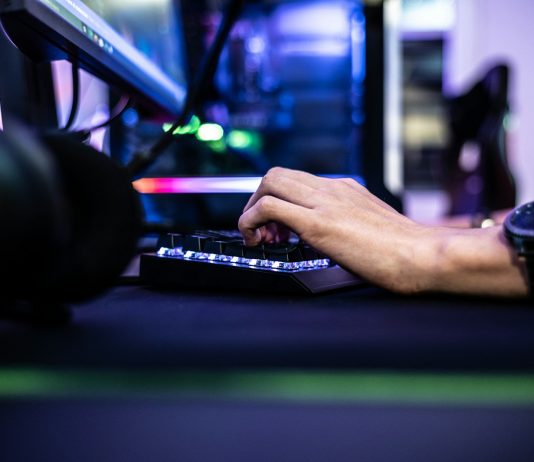 Enjoygm—Gamers’ New Choice for Cheaper Top-Up a person is typing on a laptop computer