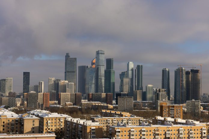 Photo by Vladlen Modern skyscrapers dominate a winter cityscape with snow.