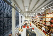 How Automated Sourcing Tools Strengthen Vendor Compliance a large warehouse filled with lots of boxes