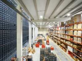 How Automated Sourcing Tools Strengthen Vendor Compliance a large warehouse filled with lots of boxes