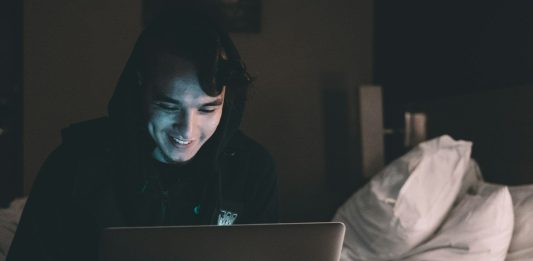 Why Crash Games Have The Buzz But Slots Still Dwarf Them By Scale person using MacBook in bed