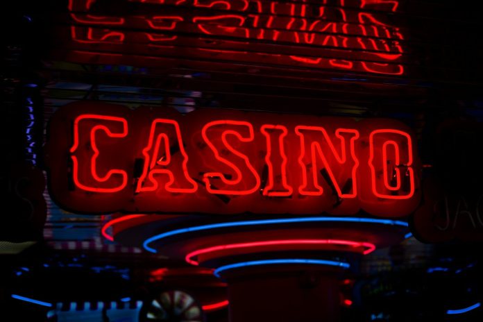 Photo by Ben Lambert red Casino neon sign turned on