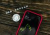 You Should Know About 5 Changes in Crypto Regulations Smartphone showing bitcoin price with a physical coin and text representing cryptocurrency investment.