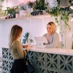 Practical Ways to Make a Local Business Look More Established woman facing on white counter