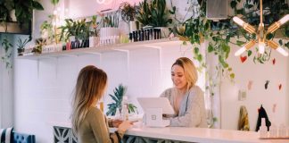 Practical Ways to Make a Local Business Look More Established woman facing on white counter