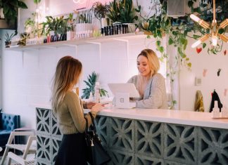 Practical Ways to Make a Local Business Look More Established woman facing on white counter