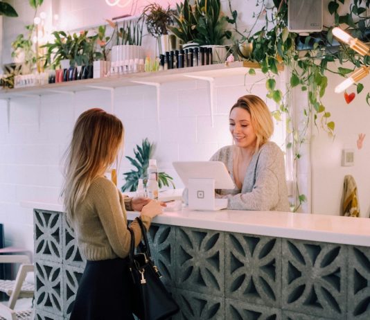 Practical Ways to Make a Local Business Look More Established woman facing on white counter